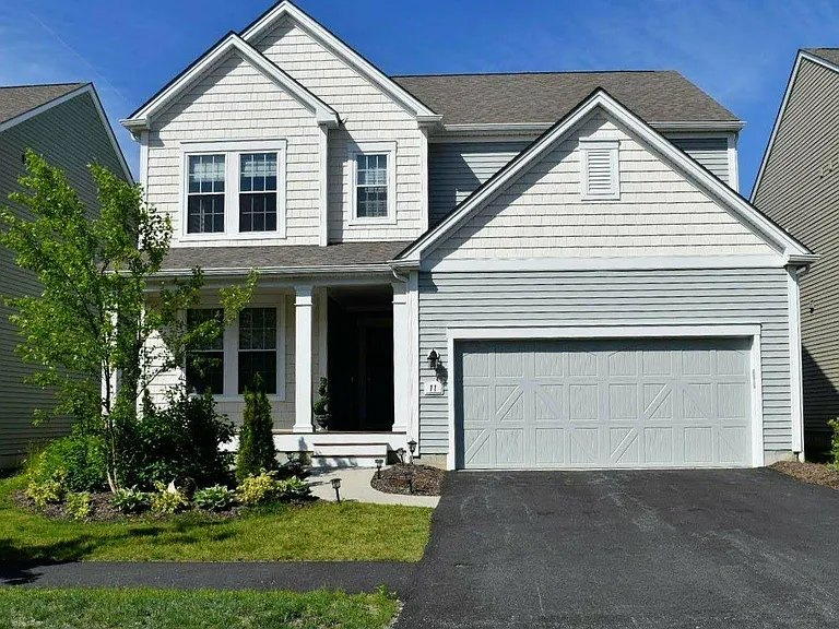 Large front porch, foyer and 2 car garage.