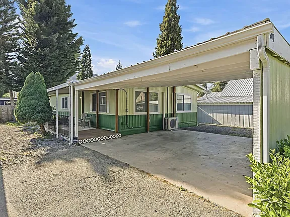 Carport attached makes easy access to home.