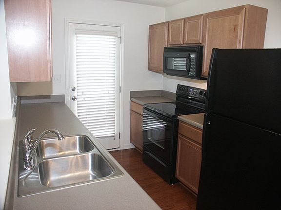 Kitchen features all black appliances, including over the counter microwave & smooth-top range.