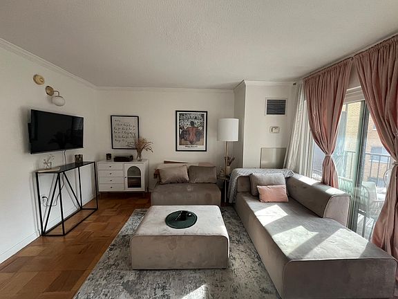 Living area with updated light fixtures and day bed couch