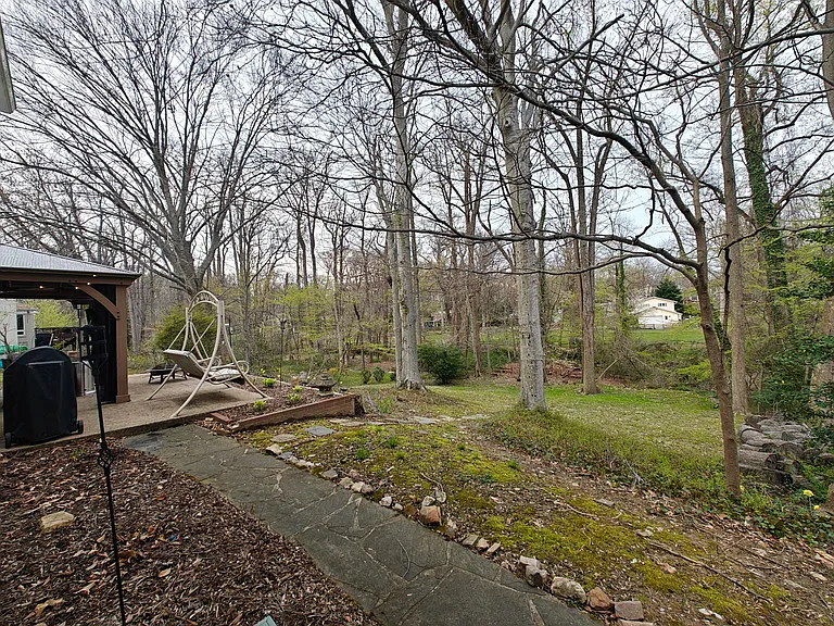 Backs to woods and creek.