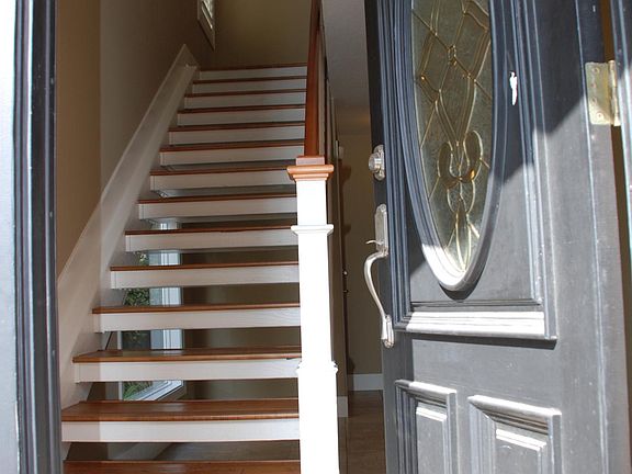 Front door entry with dramatic open stairwell