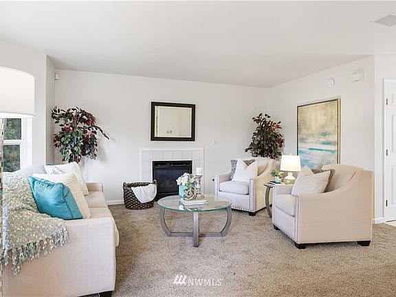 The fireplace wrapped in the neutral ceramic tiling provides a timeless palette! Notice the built-in speakers your renters will enjoy.  Six panel door package is timeless.  You'll find them throughout this unit.