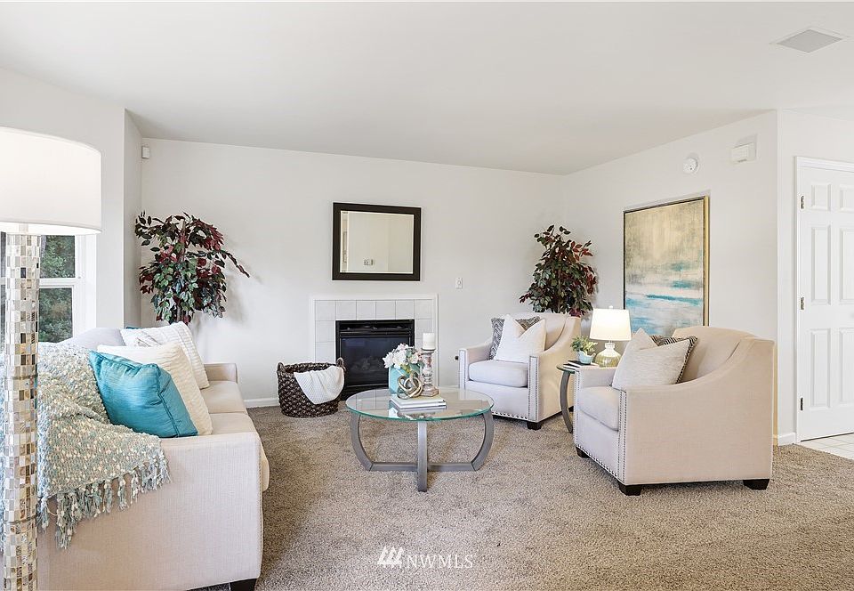 The fireplace wrapped in the neutral ceramic tiling provides a timeless palette! Notice the built-in speakers your renters will enjoy.  Six panel door package is timeless.  You'll find them throughout this unit.