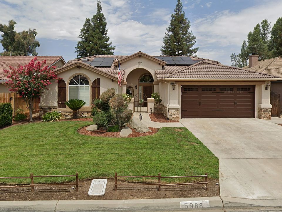 Front of home with custom built shutters, fencing, and solar.