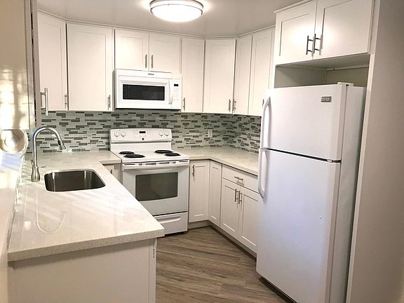 REMODELED KITCHEN WITH QUARTZ COUNTERTOPS, LARGE SINK, MICROWAVE, NEW CABINETS