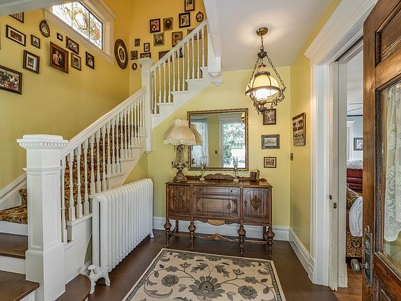 The foyer has a pocket door between the entry area and the living room area.