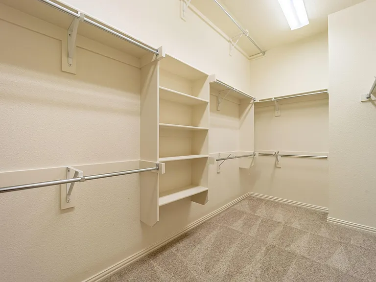 This closet is huge and has 3 rows of hanging space and built-in shelves!
