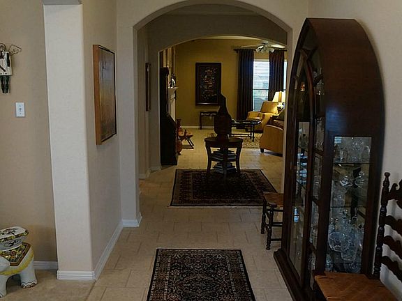 The entry way showing arches; tiled flooring through-out with carpet in bedrooms.