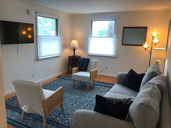 Light and comfortable livingroom with wall mounted TV