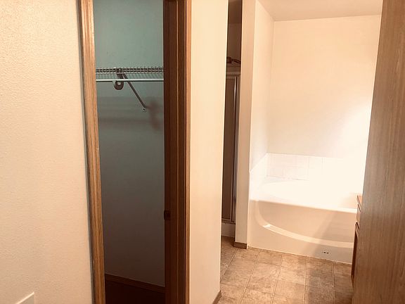 Photo of the Master bedroom walking in closet and bathtub.