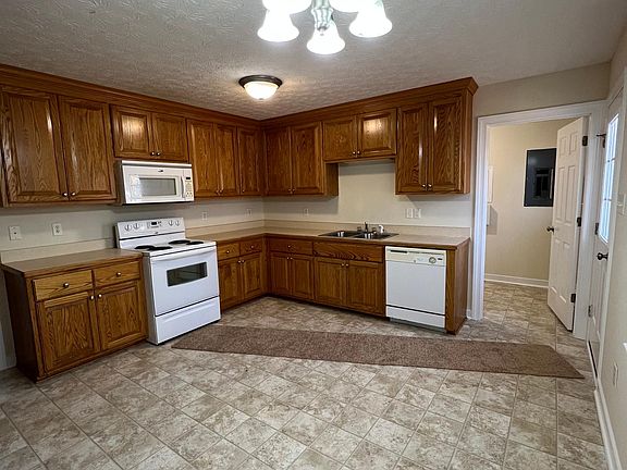 Kitchen with range, microwave and dishwasher.