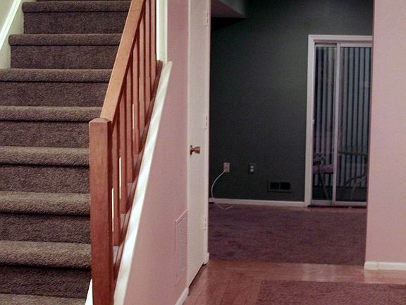 Wide open foyer area with stairs leading upstairs.