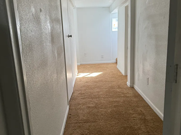 Basement hallway looking from family room / bonus room / non-conforming 3rd bedroom