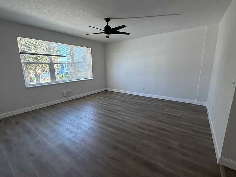 Main Living Space; can easily accommate large TV, large couch, end-tables and dining table. Elevated ceiling and fan. Side note, open the windows and get the million dollar sea breeze.