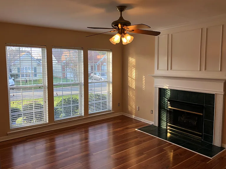 Living Room with Ceiling Fan and Fireplace