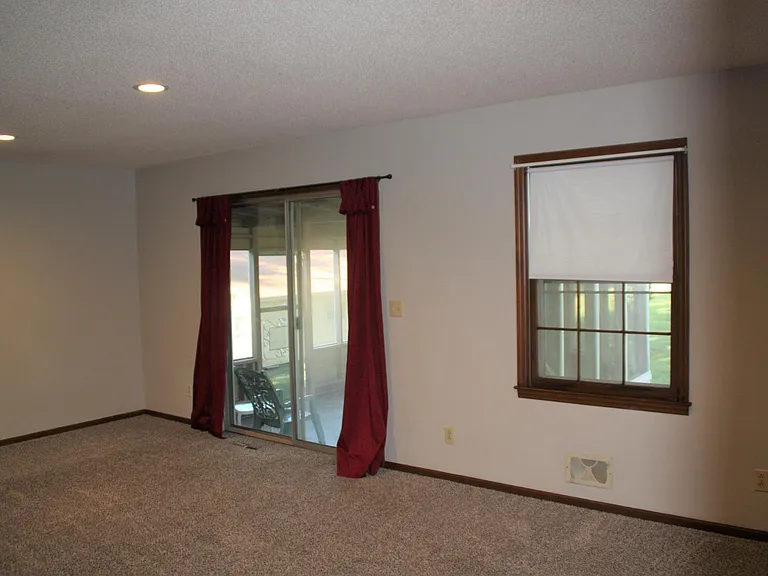 Rear living room, with screen porch entry.