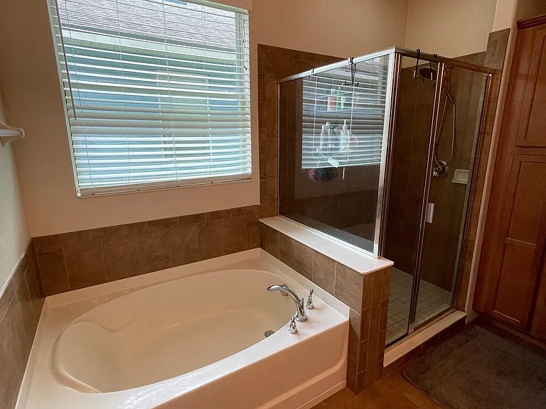 Master bathroom with separate bath tub and shower