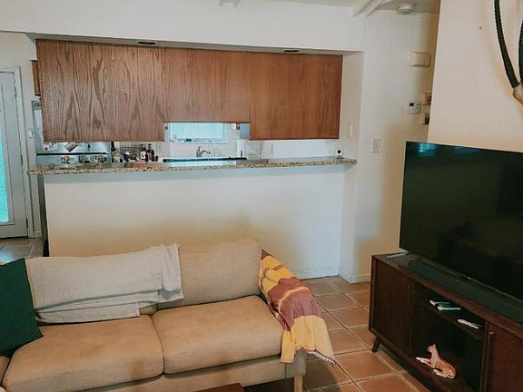 View of living area and kitchen bar area.