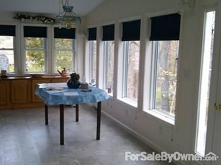 Dining Room
						:
						Dining room lined with windows, view of woods and mountain - sunsets.