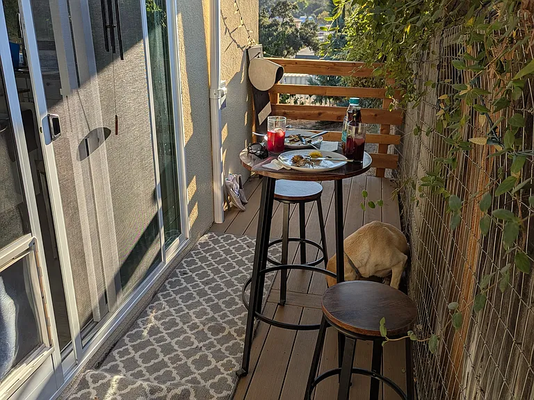 Charming private deck featuring scenic mountain views_perfect for enjoying stunning west-valley sunsets. This inviting outdoor space includes stylish patterned flooring and room for seating, offering a quiet retreat directly off the kitchen.