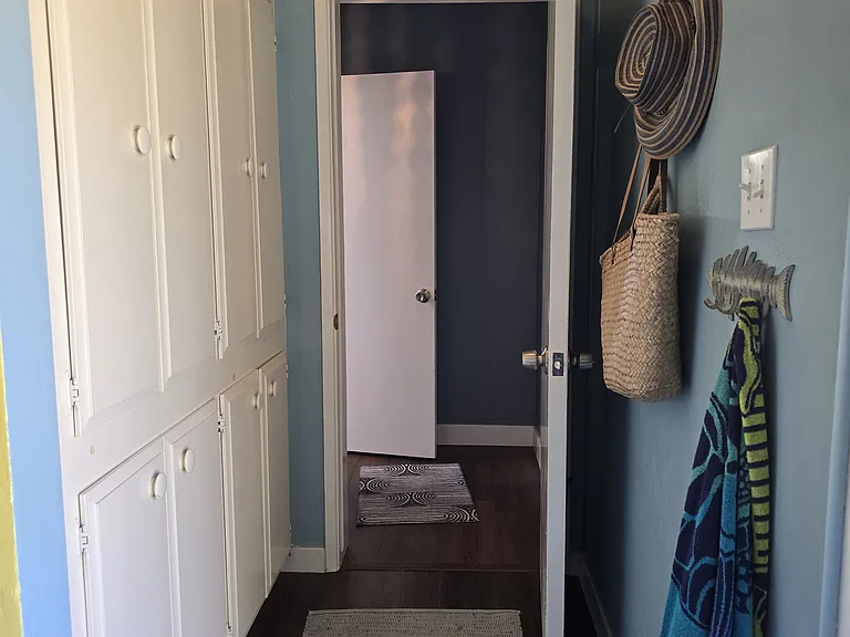 Hallway to the garage, where there is laundry and a shared overflow refrigerator. The apartment door is keyed.