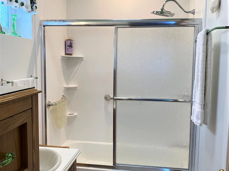 Spacious Bath offers 2 Chrome Grab Bars & natural Carrera Marble Tile Floors