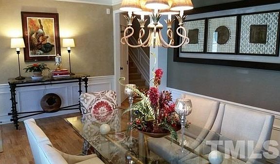 Custom paint, tray ceiling, access to foyer with crown molding, wainscott