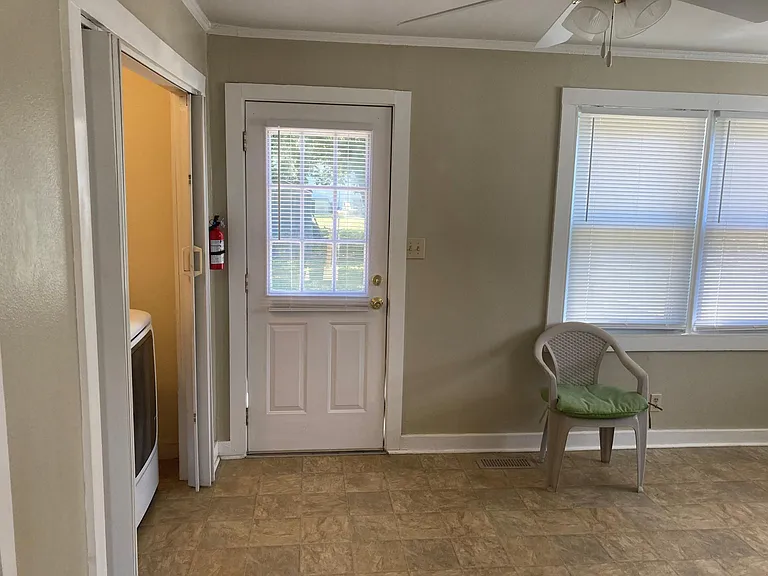 Door to back deck with washer and dryer to the left.