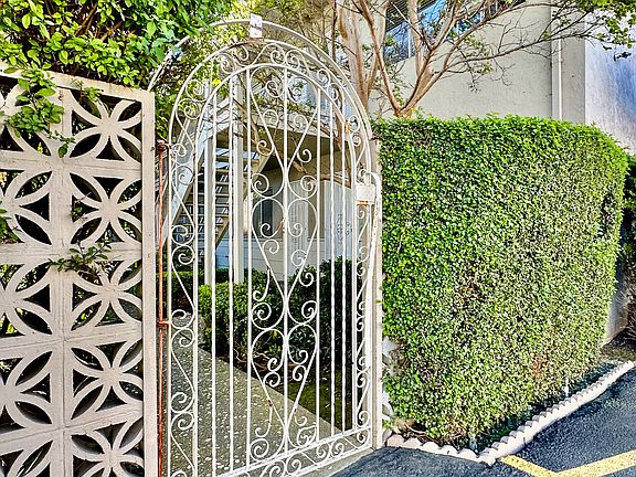 a wrought iron gate in front of a house