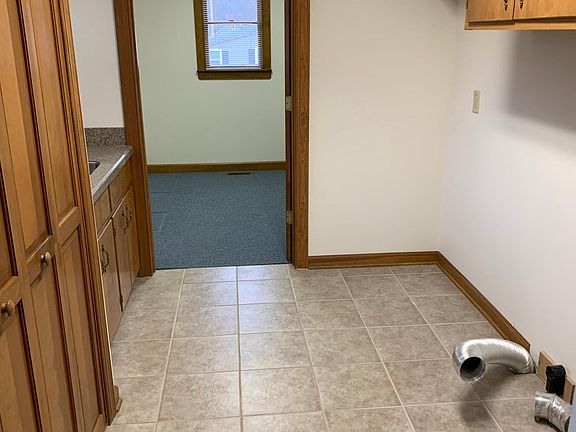Laundry area with sink and storage closet
