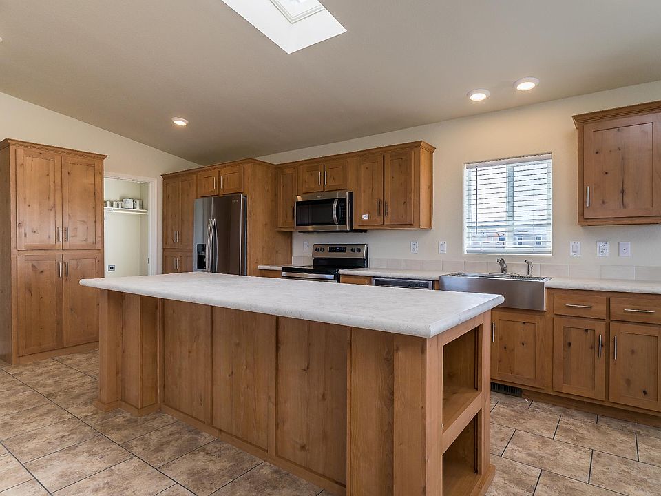 Kitchen - Solid wood cabinets, upgraded stainless appliance package, upgraded nickel hardware, large kitchen island, title back splashes, country farm sink, skylight, recessed lighting.