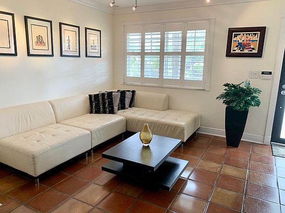 Main living room area, with fully adjustable MR 16 suspended track & plantation shutters.