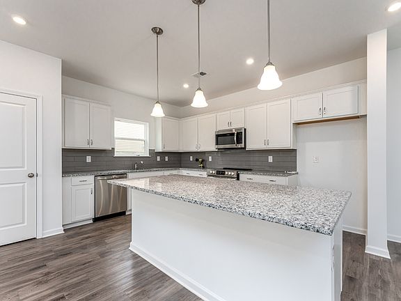 Oversized island included great for entertaining. This picture is from Ellenwood plan on a differen