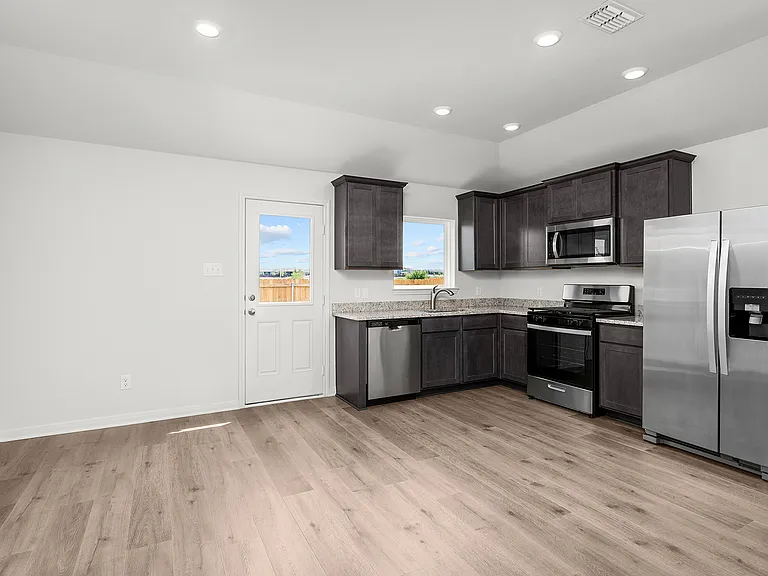 The dining area sits adjacent to the kitchen in the Ash.