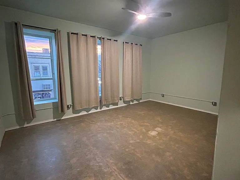 Bedroom #1: ample space, large windows, in unit AC with remote, several outlets, and closet space.