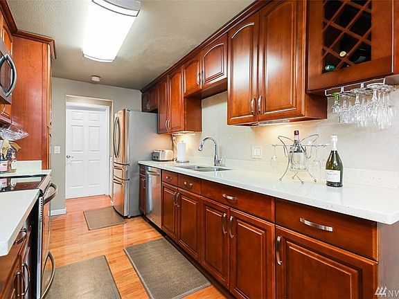 Kitchen with quartz countertop wood cabinet and stainless steel appliances
