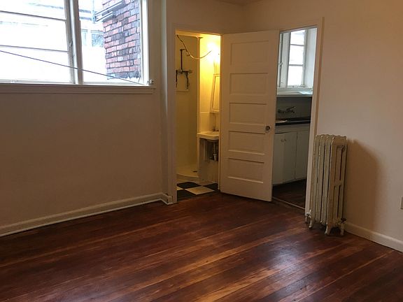 Living room with kitchen and bath entry