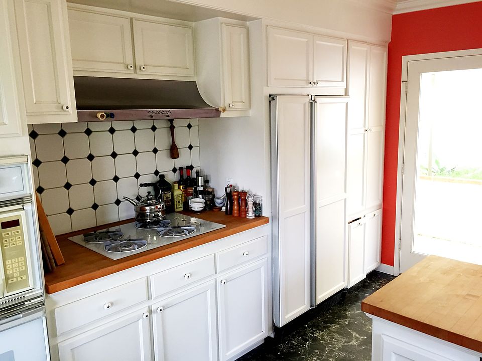 Kitchen windows and doors face private outdoor area