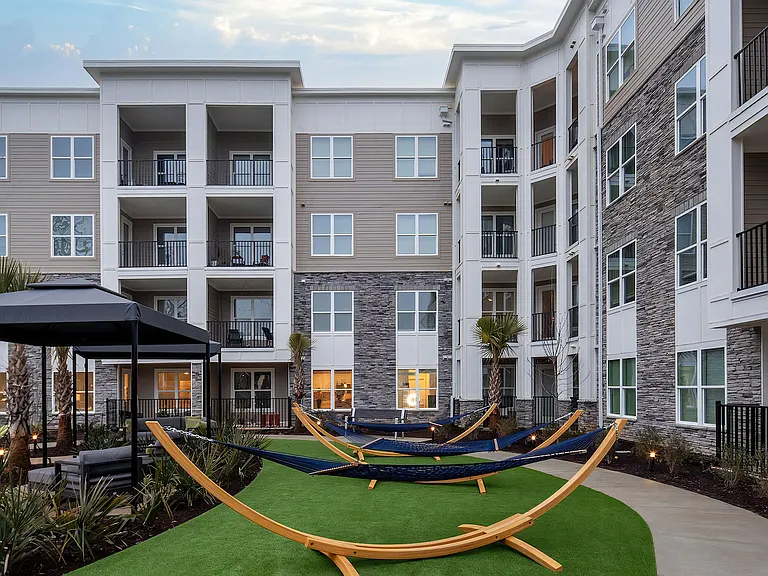 Outdoor Courtyard with Cabanas, Hammocks, and Lush Landscaping