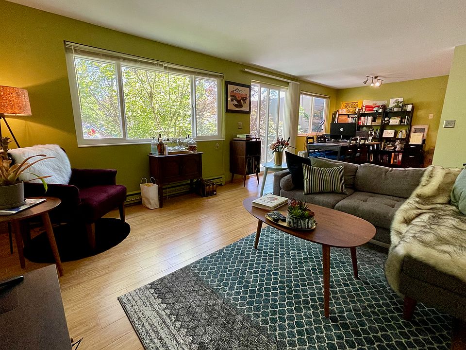 Living room with dining area in background. Great natural light with windows on 3 sides of this top floor apartment.