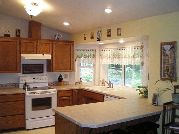 Nice bright kitchen! The sink is on the right with the big windows that face out to the backyard and