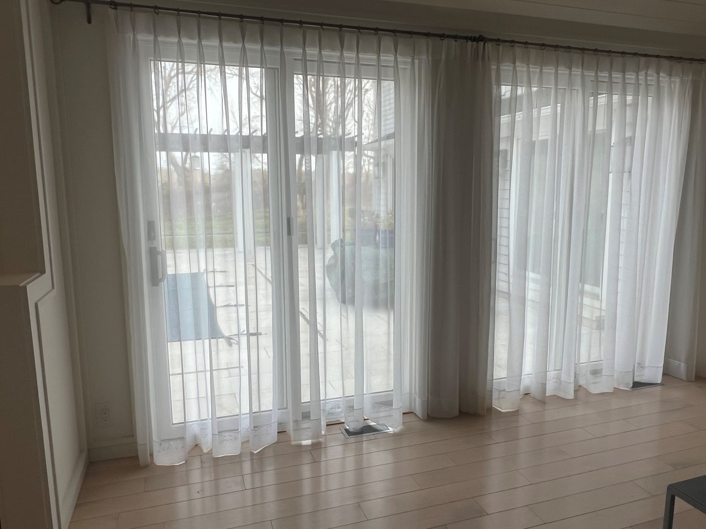 Seamless indoor–outdoor living—thanks to five sliding glass doors that open to a heated gunite pool