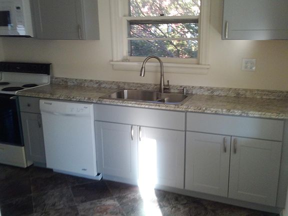 Remodeled kitchen with new flooring, cabinets, countertops,