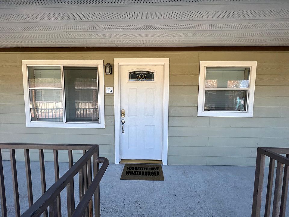 Front door and windows of this second-floor unit.