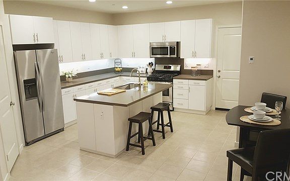 Open kitchen and breakfast nook is spacious and light-filled