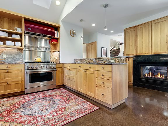 Double sided gas fireplace and heated concrete floors.