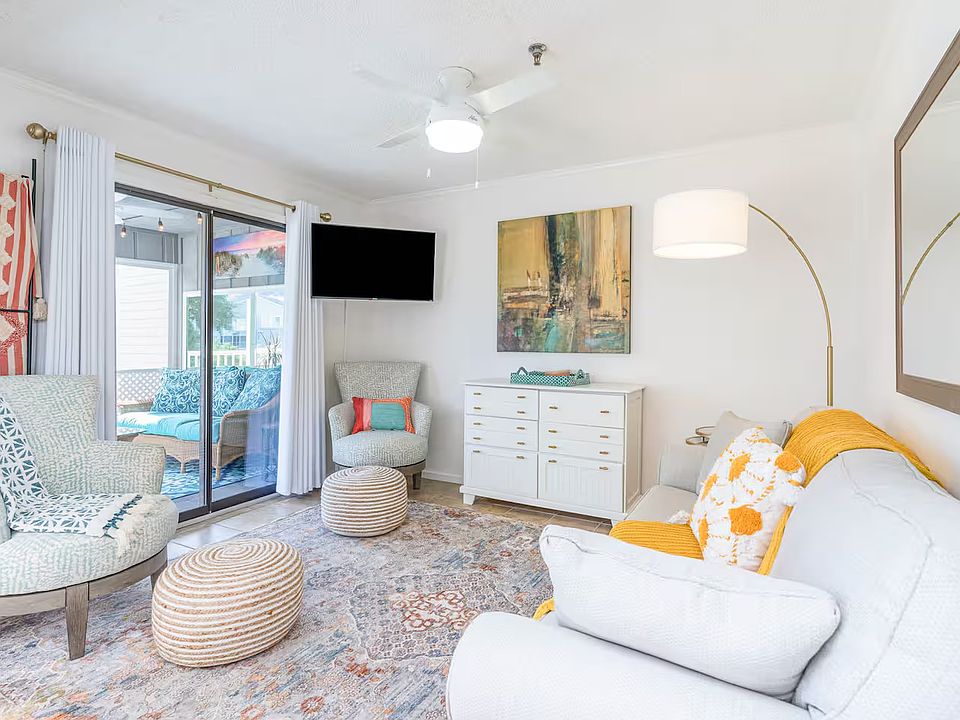 Living Area with queen sleeper sofa, smart TV. Opens to the sunroom.