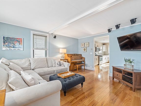 Comfy living room with piano and TV for streaming from your favorite apps.
