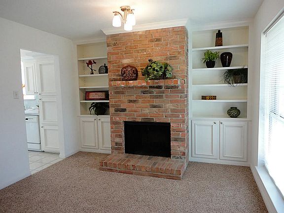 Bonus...this warm and inviting room showcases raised hearth fireplace flanked by custom bookcases...could be your home office, a formal living space, or formal dining...your choice of use!